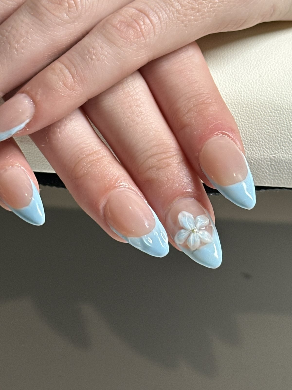 Baby blue almond French acrylic set with a hand-sculpted white 3D flower accent nail